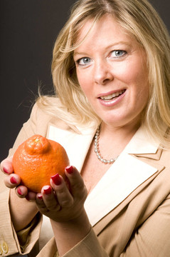 迷人的金發(fā)女人Mineola橙色Tangerine夜店新鮮水果的健康生活