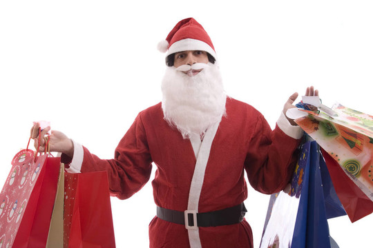 年輕人在Santa服裝；充滿了禮物