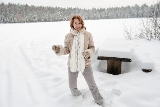 女人成熟的成人快樂的冬天森林的雪自然