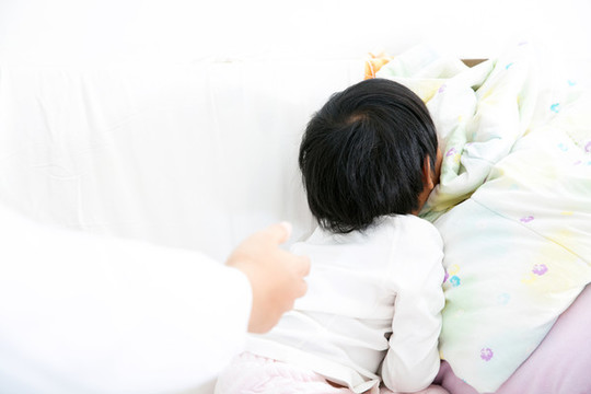 醫(yī)生召喚趴在被子上的小女孩患者