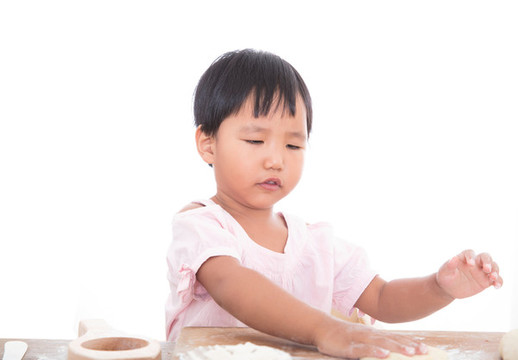 白背景前中國(guó)小女孩在學(xué)習(xí)做月餅