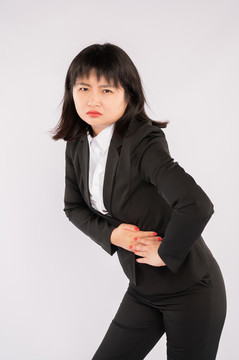 商業(yè)女性皺眉頭按壓肚子