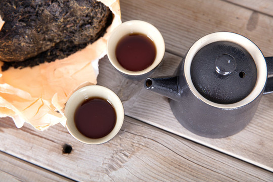 黑磚茶和茶杯茶壺在桌子上
