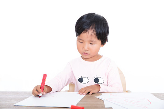 可愛的中國(guó)小女孩在認(rèn)真的畫畫