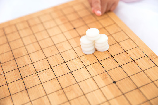 一摞白色棋子在棋盤上