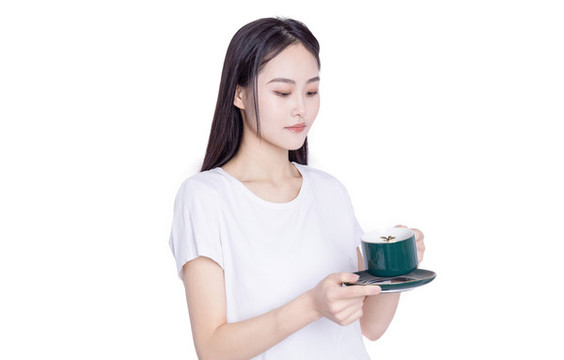 年輕的女性端著咖啡杯