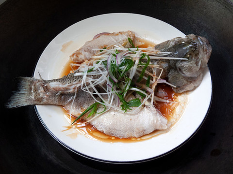 放在鐵鍋里清蒸烹飪的鱸魚