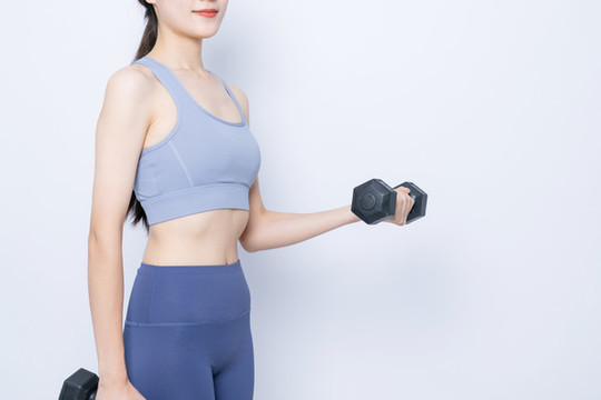 手持啞鈴健身的東方女性