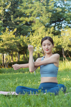 草地上做瑜伽動(dòng)作的女性