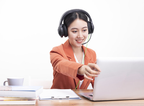 戴著耳機(jī)正在教網(wǎng)課的女老師