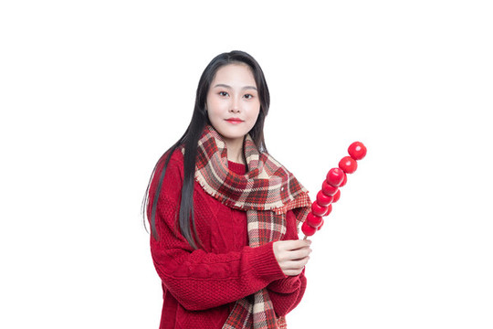 手持冰糖葫蘆的年輕女性
