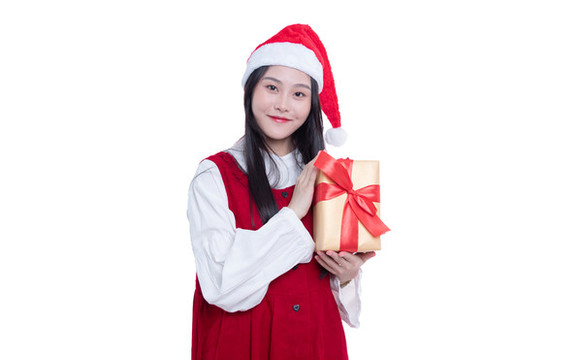 圣誕節(jié)拿著禮盒的年輕女性