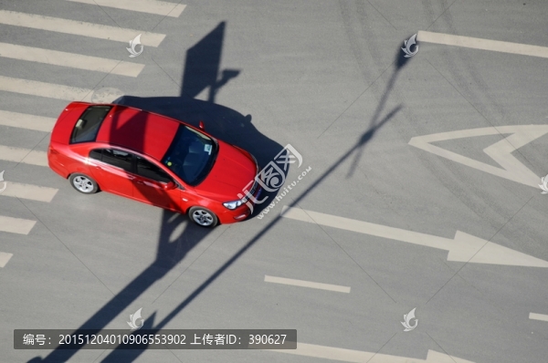 通過(guò)路口的紅色小轎車