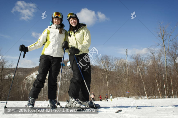 兩個年輕女孩在山頂上滑雪