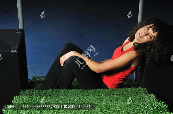 年輕女子放松與草地表面綠色樓梯