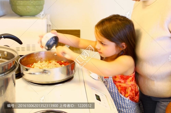 幫媽媽做飯的小女孩