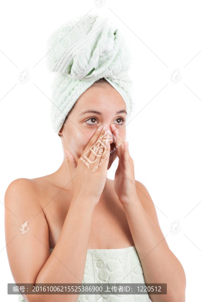 年輕的女人在她的臉上涂奶油