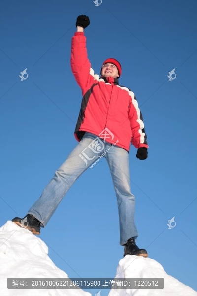 男子在紅色上衣頂部的雪山與手
