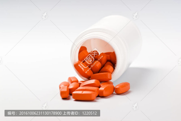 從瓶子里溢出的橙色藥丸