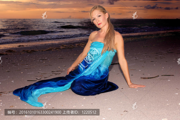 夕陽下的海灘上的女人