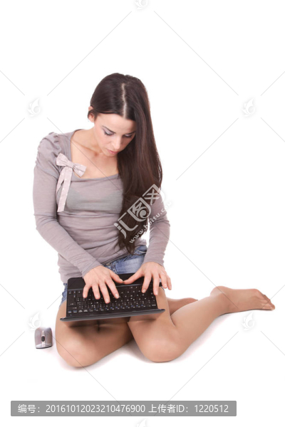 休閑婦女與筆記本電腦；工作在地板上。