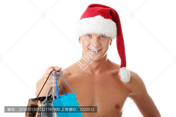 性感的肌肉赤裸上身的男子在圣誕老人的帽子