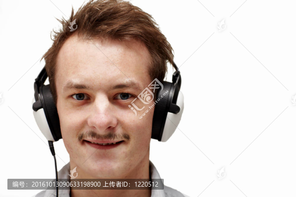 英俊的年輕人聽音樂的白色