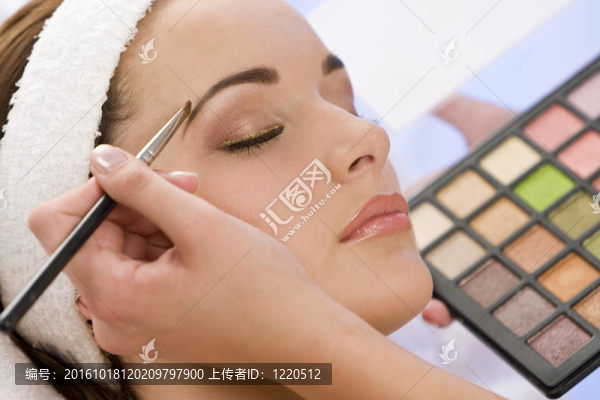 美麗的女人涂脂抹粉在斯帕的美容師