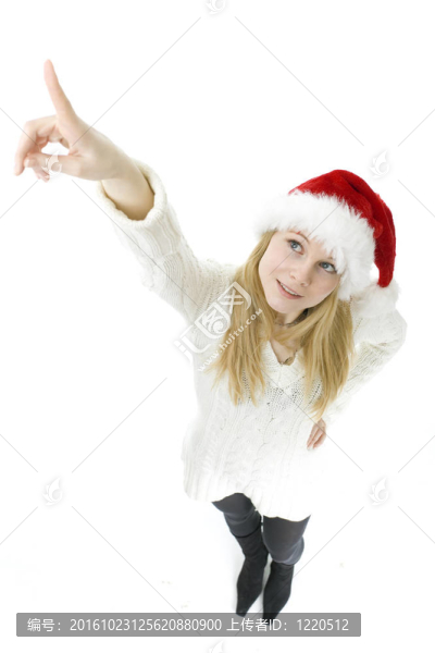 年輕女子在紅色圣誕帽指向