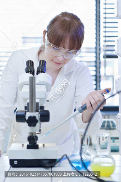 漂亮的女研究員在實(shí)驗(yàn)室用顯微鏡