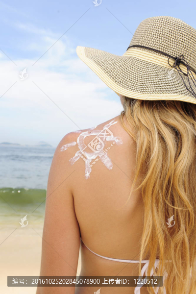 防曬油在沙灘上的女人