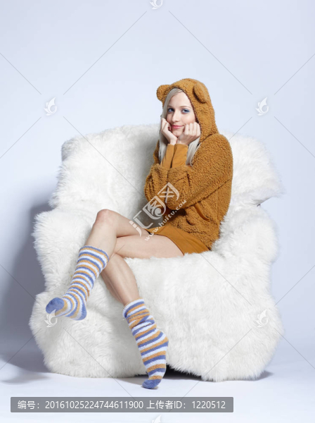 棕色毛絨HUD坐在扶手椅上的女孩