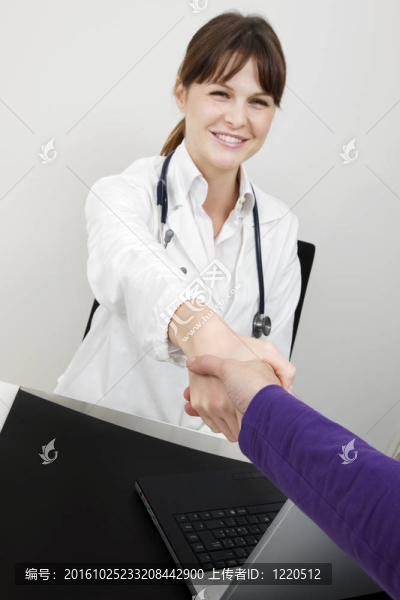 年輕白人婦女醫(yī)生和病人握手