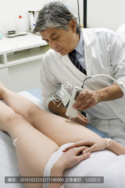 白人女子接受激光治療的腿從男性醫(yī)生