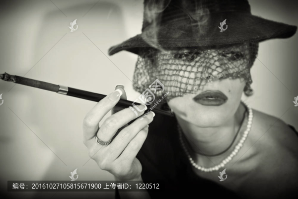 戴面紗的戴著煙嘴的香煙的女人