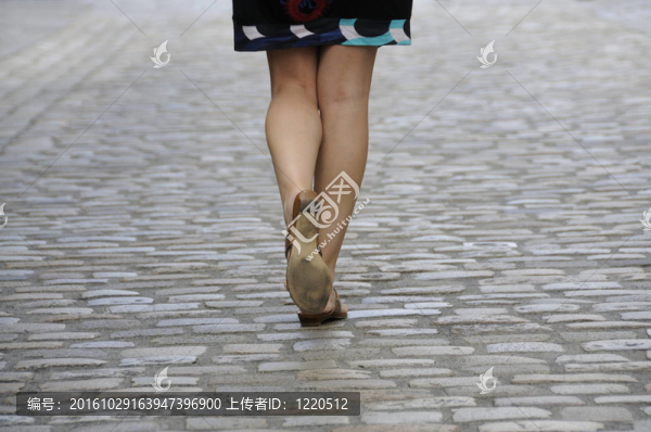 女人走在鵝卵石路面