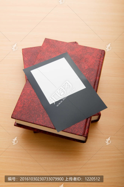 木制桌子上的書(shū)和空白照片