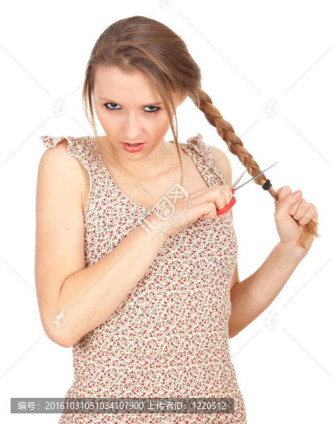 年輕婦女用剪刀試圖剪她的頭發(fā)