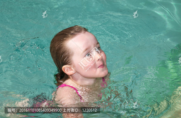 在夏日的炎熱中游泳的少女。
