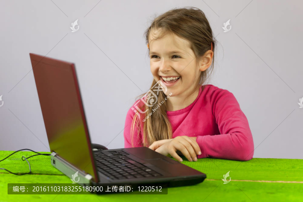 隨著筆記本電腦的七歲的女孩
