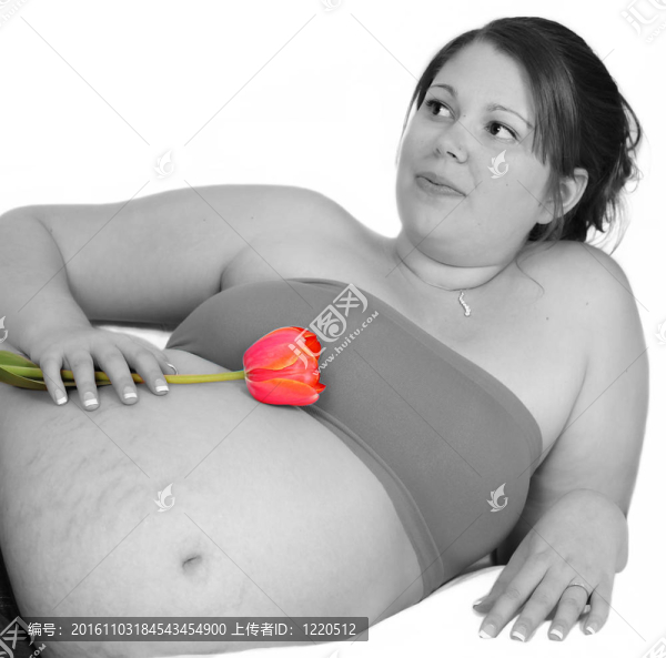 妊娠婦女抱著色彩鮮艷的橙色郁金香選擇圖像