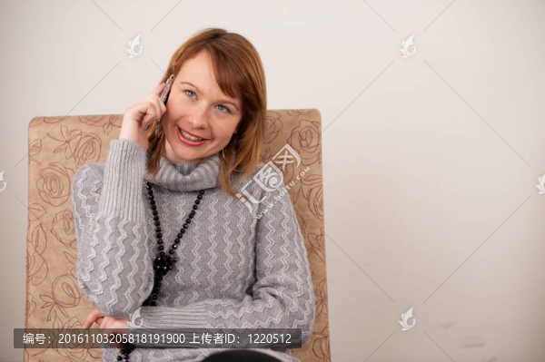 漂亮女孩在舒適的咖啡館里用手機說話。