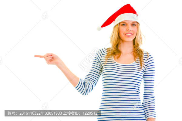 美麗的少女在Santa帽子指著角落