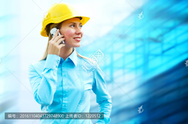 站在建筑物背景上的年輕建筑師女士戴著防護(hù)頭盔