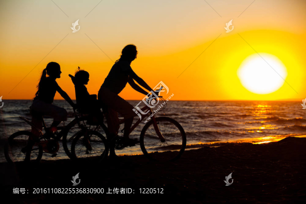 母親和她的孩子在自行車上的剪影