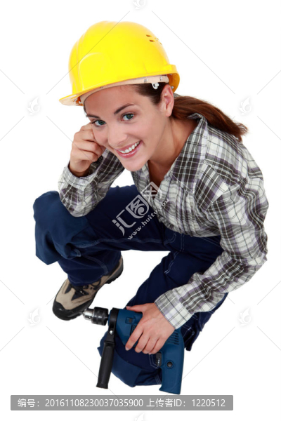 帶鉆孔的女建筑工人。