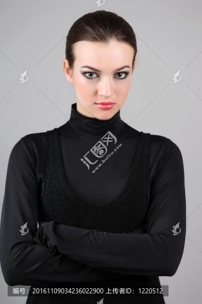 站在灰色背景上的年輕女子