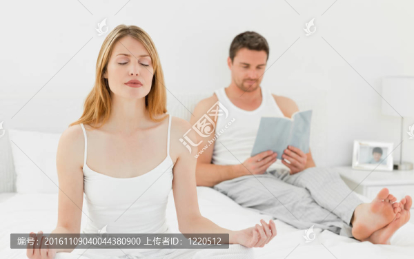 女人練習(xí)瑜伽，而丈夫在讀書(shū)