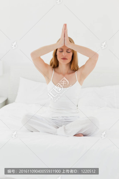 女人在她的床上練習(xí)瑜伽