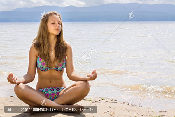 美麗的年輕女子在海邊冥想